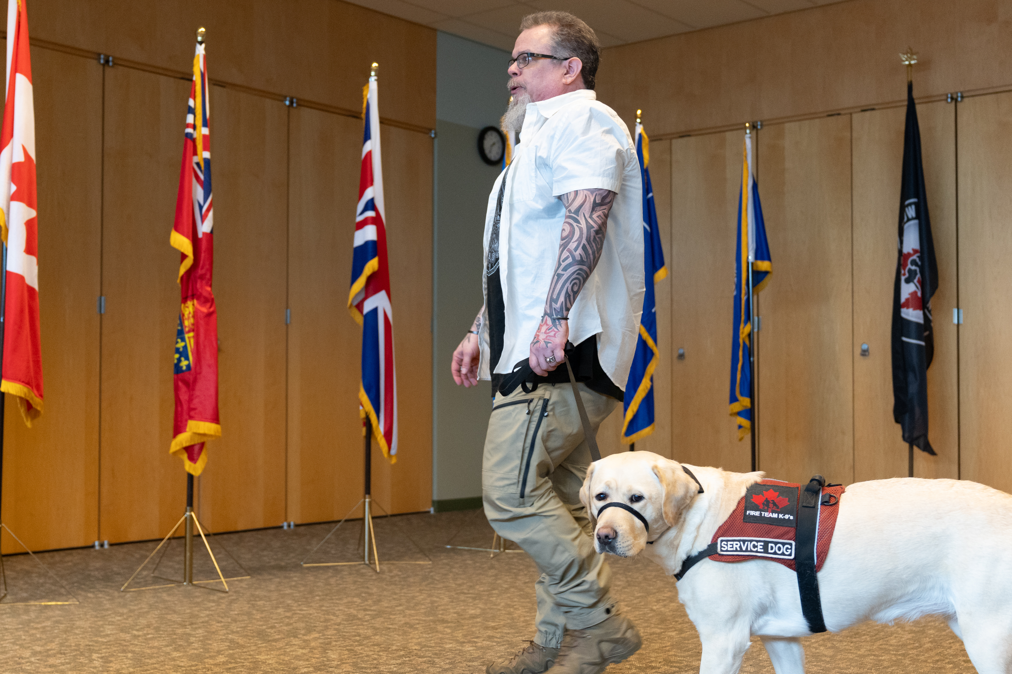 A Veteran walking with his service dog